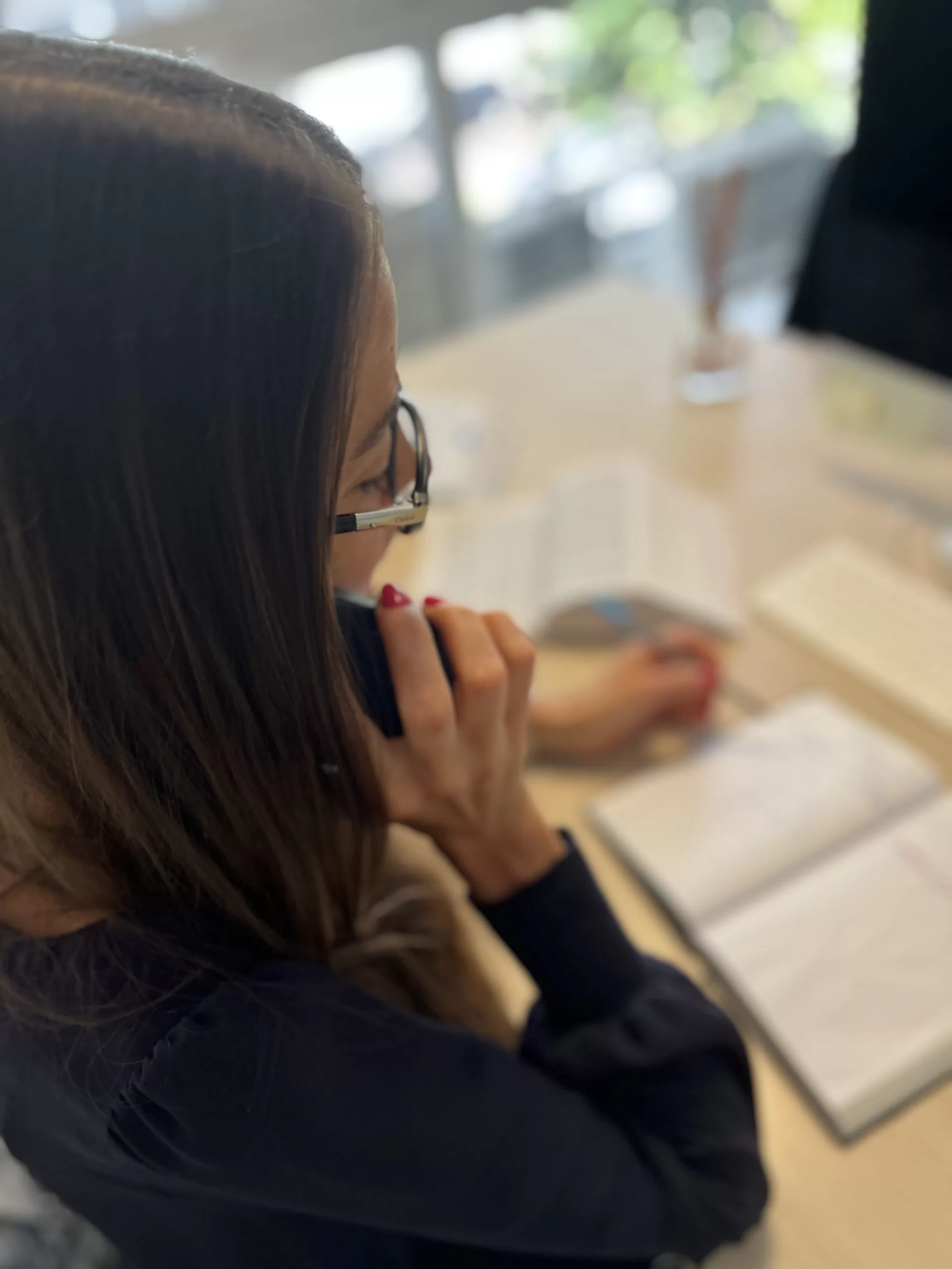 Louise Bregman Personne au téléphone qui regarde un livre
